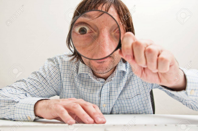 11597072-funny-image-of-a-business-person-with-a-magnifying-glass-one-eye-is-enlarged-.jpg